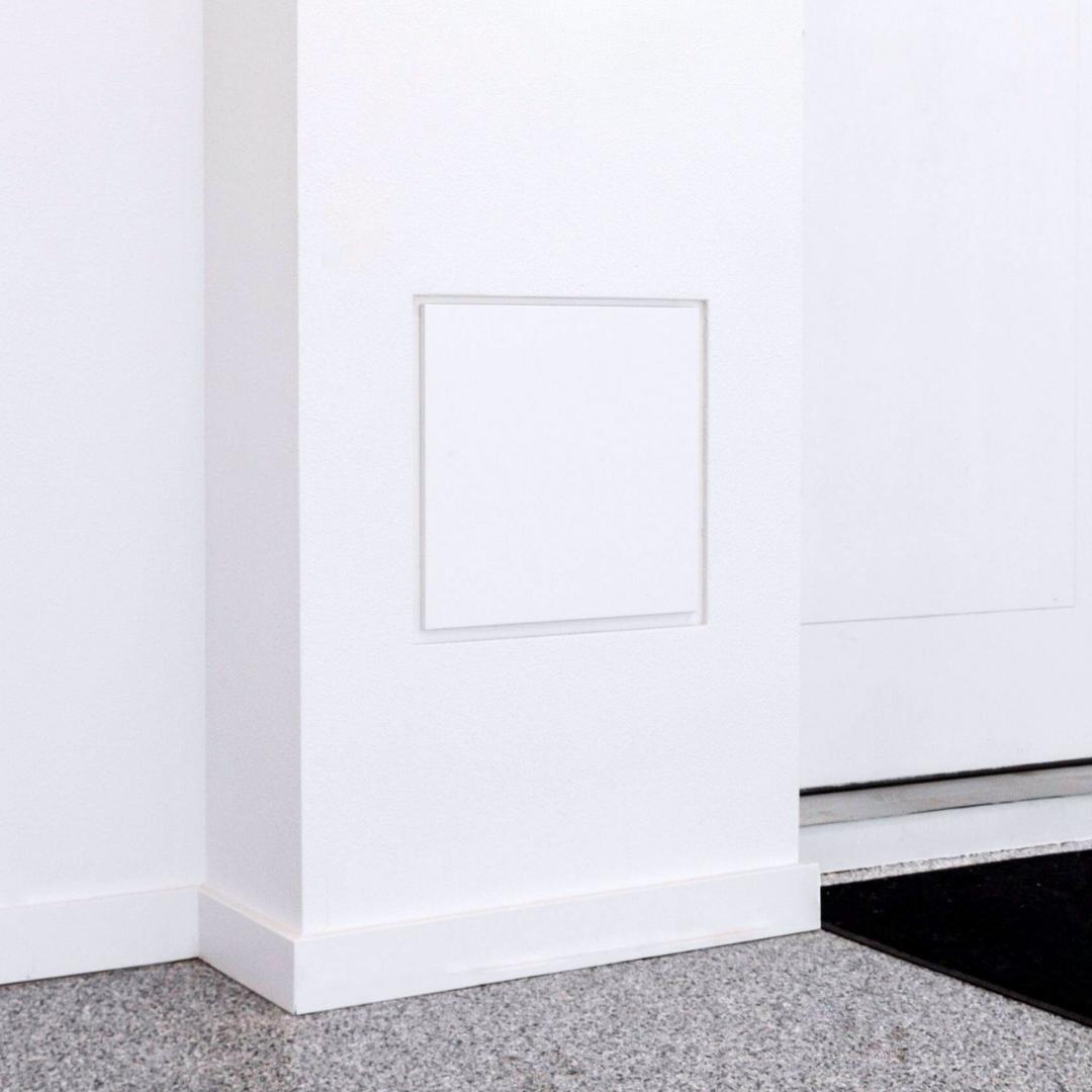 Painted drywall access panel concealing plumbing shut-off valves