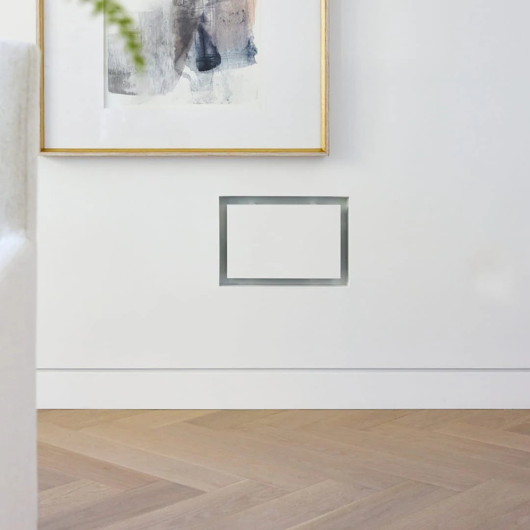 Paintable wall return air vent blending into a painted plaster wall